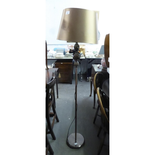 310 - A MODERN BRASS STANDARD LAMP AND GOLD COLOURED SHADE