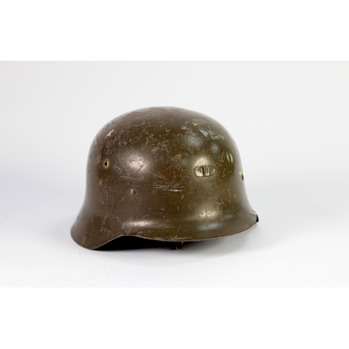 29 - GERMAN WORLD WAR II STEEL HELMET, with original green painted finish, interior leather fittings (los... 