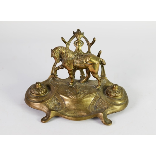 236 - EARLY TWENTIETH CENTURY BRASS DESK INKSTAND, modelled with a horse and a pair of inkwells with cover... 