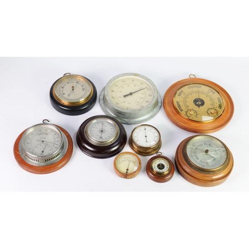 60 - NINE EARLY TWENTIETH CENTURY AND LATER WALL MOUNTED ANEROID BAROMETERS, in circular cases, 3 ½”- 9 ½... 