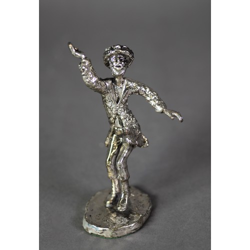 430 - ISRAELI SILVER COLOURED METAL CASED FIGURE of a man in dancing pose, on oval base, 5 ½” (13.9cm) hig... 