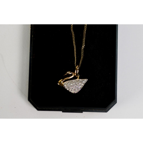 407 - SWAROVSKI GOLD PLATED AND CRYSTAL SET SWAN PATTERN PENDANT on fine chain necklace, in associated vis... 