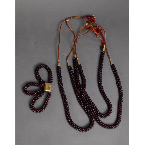 441 - THREE ORIENTAL GARNET BEAD NECKLACES and a garnet bead triple strand BRACELET