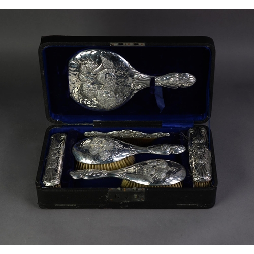 373 - EDWARD VII EMBOSSED SILVER BACKED SIX PIECE DRESSING TABLE HAND MIRROR AND BRUSH SET IN ORIGINAL FIT... 