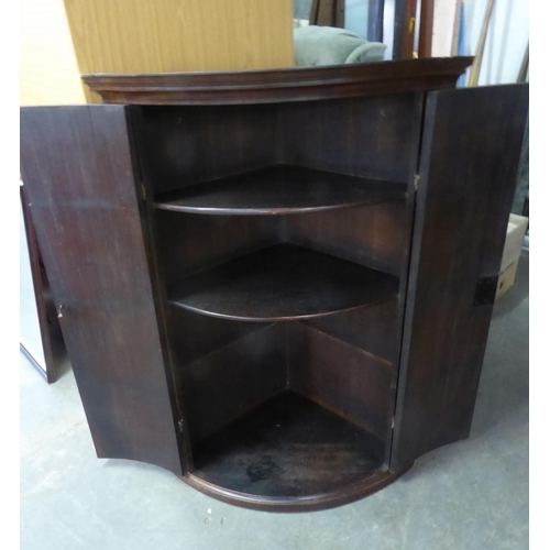 262 - A MAHOGANY ANTIQUE BOW FRONTED CORNER CABINET, WITH 'H' HINGES (LACKING ONE SHELF) 106cm high