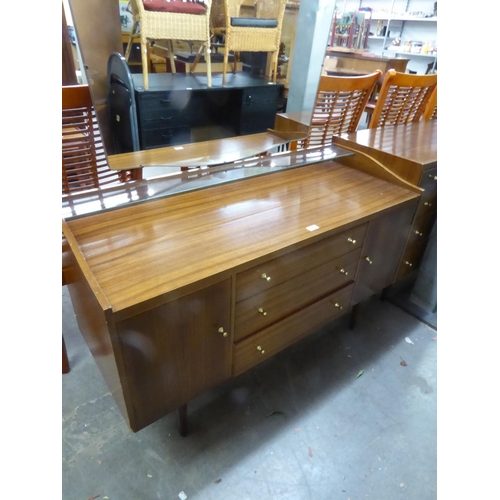 296 - WRIGHTON 1960S TEAK DRESSING TABLE WITH FRAMELESS MIRROR, THREE CENTRE DRAWERS AND END CUPBOARDS, ON... 