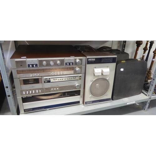 10 - THREE OLD TYPEWRITERS IN CASES AND AN AMSTRAD STEREO SYSTEM WITH SPEAKERS