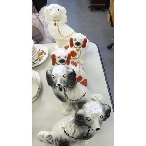 94 - TWO PAIRS OF TWENTIETH CENTURY STAFFORDSHIRE POTTERY MANTEL DOGS, THE SMALLER PAIR WITH IRON RED DET... 