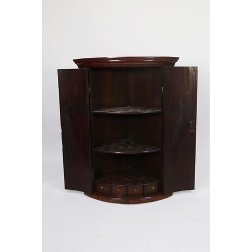 123 - GEORGE III FIGURED MAHOGANY BOW FRONTED CORNER CUPBOARD, of typical form with four spice drawers and... 