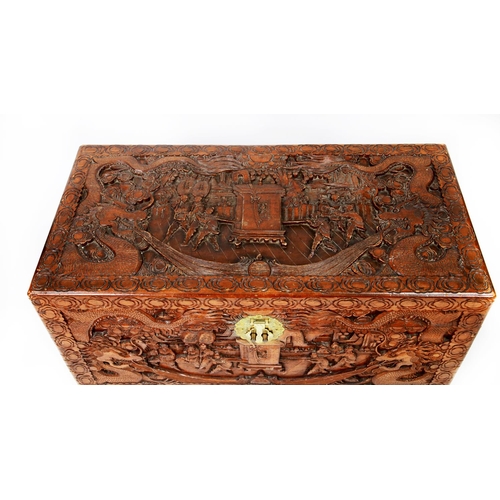 124 - CHINESE CARVED CAMPHOR WOOD BEDDING BOX, of typical form with hinged lid and engraved brass lock to ... 