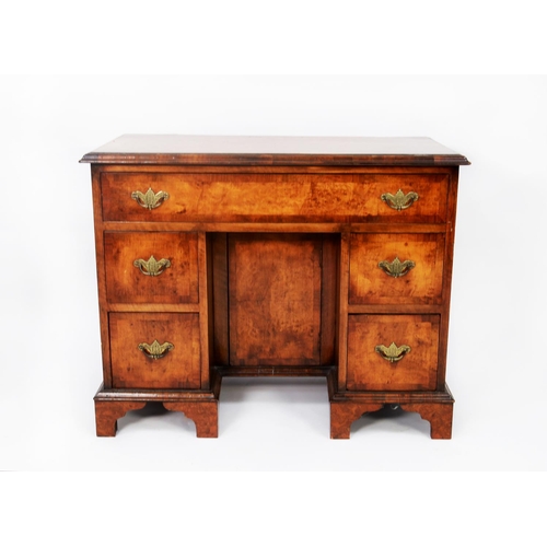 110 - TWENTIETH CENTURY GEORGE II STYLE FIGURED WALNUT AND CROSSBANDED KNEEHOLE DESK, the moulded oblong b... 