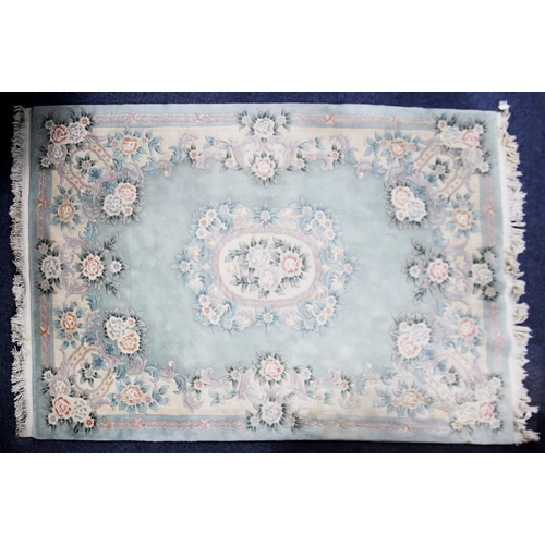 28 - WASHED CHINESE EMBOSSED CARPET OF AUBUSSON DESIGN with white and floral oval centre medallion and ir... 