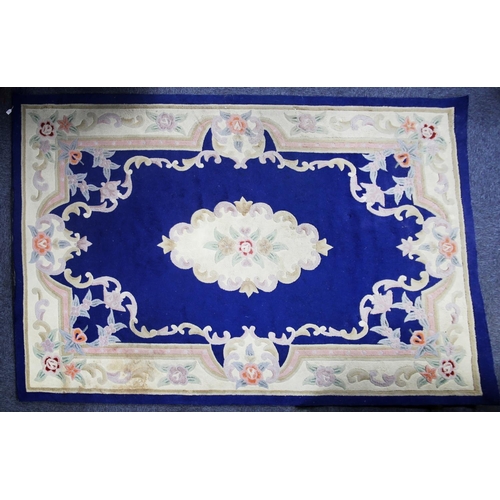 29 - CHINESE ACRYLIC CARPET OF AUBUSSON DESIGN with white and floral centre and border, plain royal blue ... 