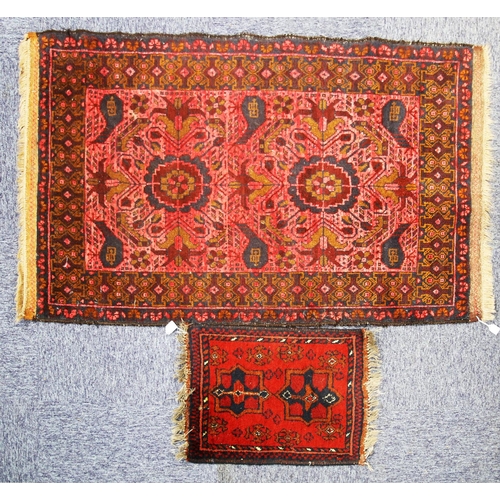 21 - SHIRAZ PERSIAN RUG with two large floral medallions on a pink field, the principal border wine red a... 