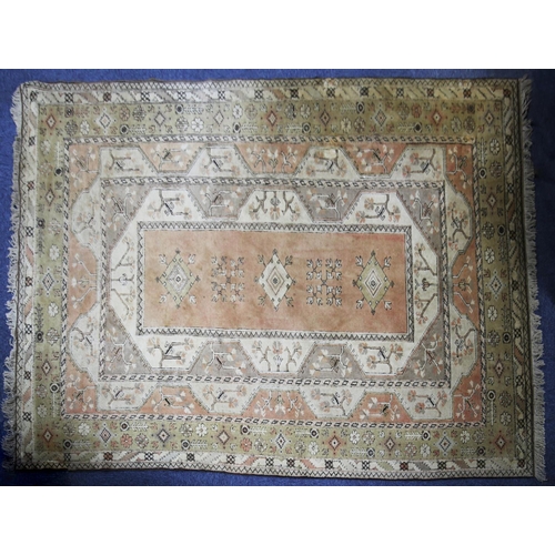 25 - EASTERN HAND WOVEN BORDERED CARPET predominantly fawn, pale pink with brown stencilling, having a la... 