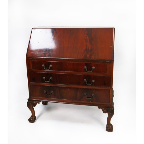 152 - CHIPPENDALE STYLE FLAME FIGURED MAHOGANY BUREAU with sloping fall-front suppirted by self-advancing ... 