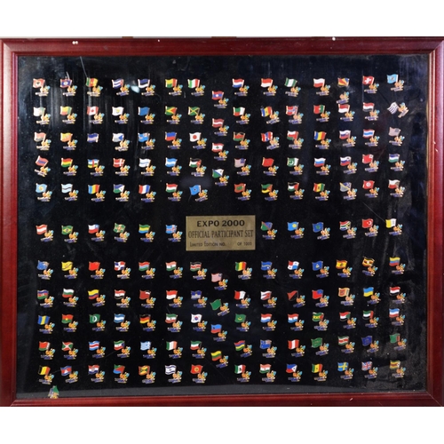 280 - EXPO 2000 FRAMED LIMITED EDITION SET OF GILT METAL AND ENAMEL PARTICIPANT'S BADGES, No 111/1000, app... 