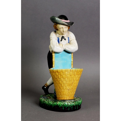 349 - MINTON MAJOLICA FIGURE OF A BOY WITH GRAPE BASKET AND VINE, model number 421, one of a pair; 9 1/2