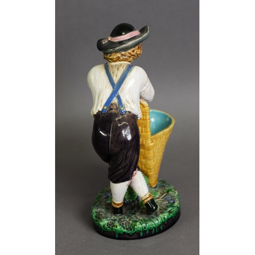 349 - MINTON MAJOLICA FIGURE OF A BOY WITH GRAPE BASKET AND VINE, model number 421, one of a pair; 9 1/2