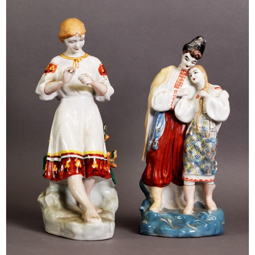 287 - TWO MODERN RUSSIAN PORCELAIN FIGURES, one modelled as a couple in traditional dress, 10 ½” (26.7cm) ... 