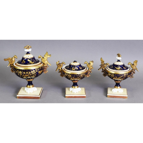 284 - THREE PIECE LATE NINETEENTH/ EARLY TWENTIETH CENTURY PORCELAIN GARNITURE OF TWO HANDLED PEDESTAL POT... 