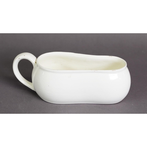 302 - NINETEENTH CENTURY CREAMWARE POTTERY BOURDALOUE, of waisted form with moulded scroll handle, 9 ½” (2... 