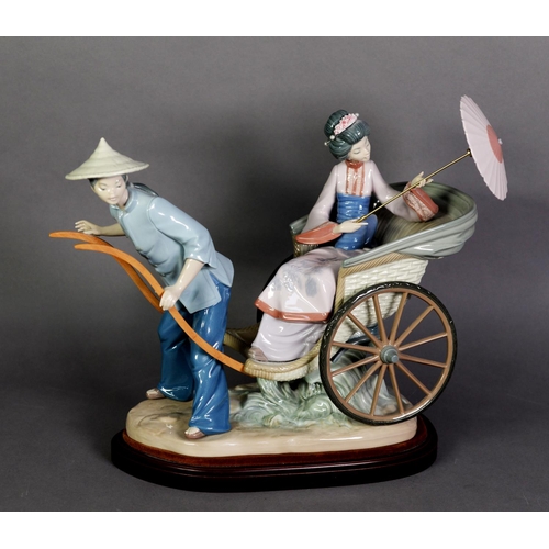 549 - LLADRO, Spanish porcelain large group of a man pulling a rickshaw, with Geisha passenger holding a p... 