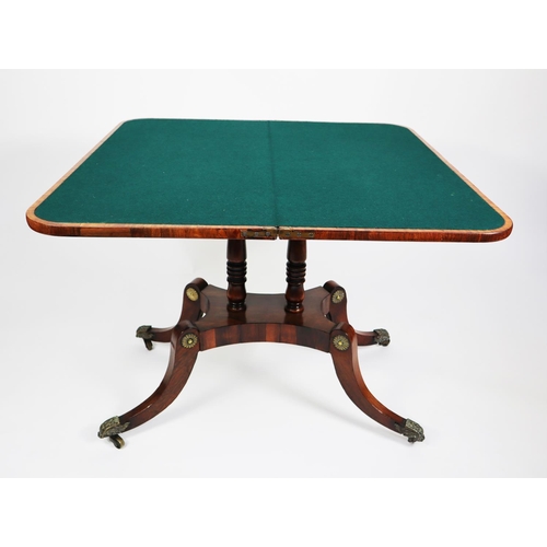 472 - REGENCY ROSEWOOD FLAP TOP CARD TABLE, with broad satinwood cross banding and brass stringing and cut... 