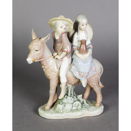 540A - LLADRO, Spanish porcelain group of a boy and girl riding on a donkey, on oval base, 7 ½” (19 cm) H