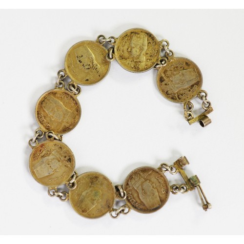 63 - BRACELET COMPRISING 7 KING FARRUK 10 QUIRSH COINS, 1937 - 1939, chain linked, each 20mm in diameter,... 