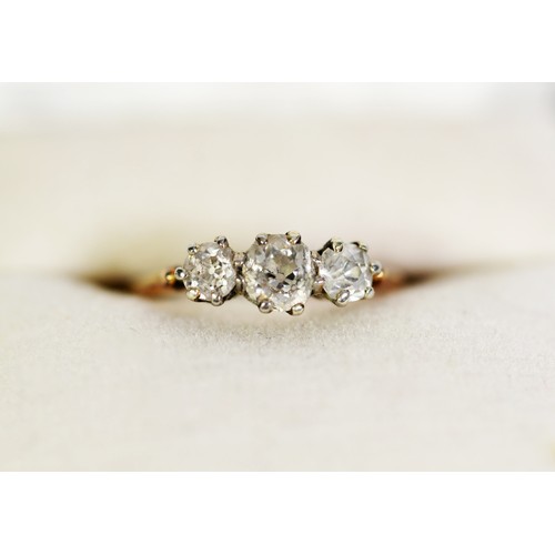 90 - 18ct GOLD AND PLATINUM RING set with three old cut round diamonds, the centre stone approximately .4... 