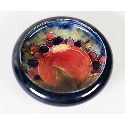 116 - WILLIAM MOORCRCOFT ‘POMEGRANATE’ PATTERN TUBE LINED POTTERY SMALL DISH, painted in tones of red, gre... 