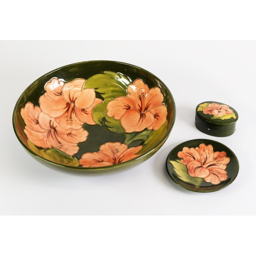 115 - THREE PIECES OF WALTER MOORCROFT HIBISCUS PATTERN TUBE LINED POTTERY ON GREEN GROUNDS, comprising: F... 