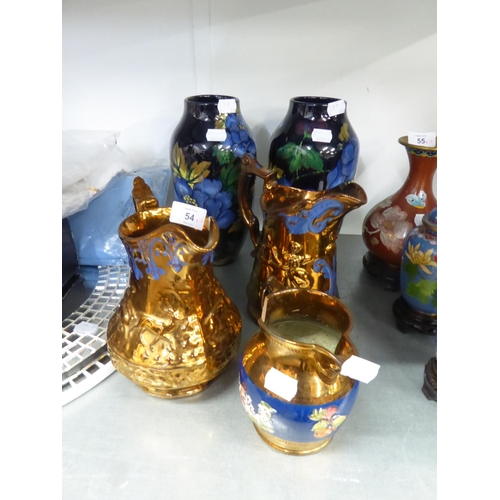 52 - TWO COPPER LUSTRE JUGS, ONE EMBOSSED WITH BALLET DANCERS, ONE WITH DEER, 8” HIGH; ANOTHER SMALLER CO... 