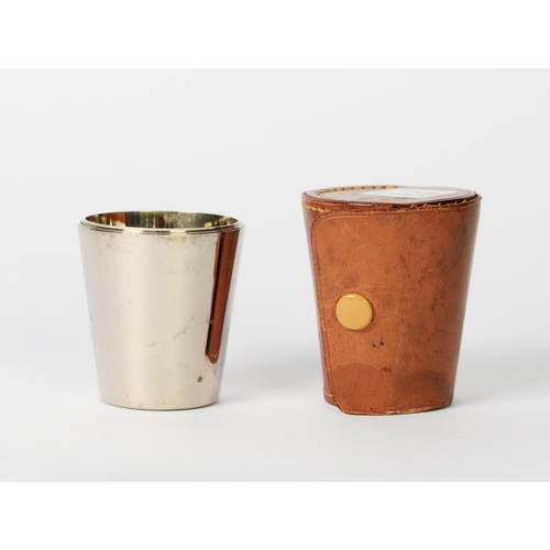 385 - SET OF FOUR GERMAN SILVER PLATED NESTING SMALL TAPERING BEAKERS with gilt interiors, in tan leather ... 