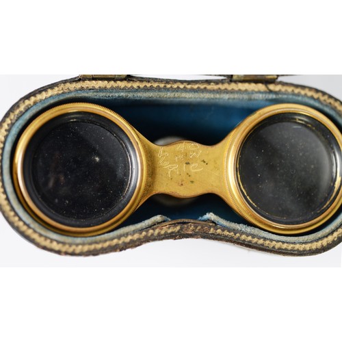 388 - PAIR OF 19th CENTURY FRENCH GILT BRASS OPERA GLASSES, with mother of pearl inset eye pieces, the bod... 