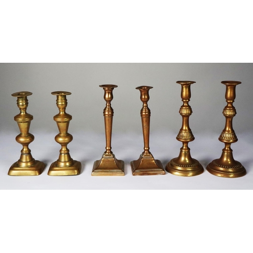 111A - THREE PAIRS OF BRASS EJECTOR CANDLESTICKS, 11” (28cm) high and smaller, (6)