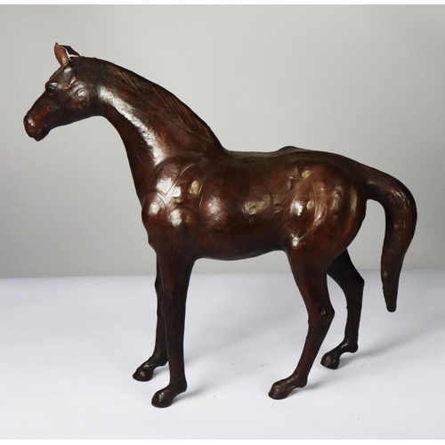 79 - MODERN BROWN LEATHER MODEL OF A HORSE, 19 ½” (49.5cm) high, to the tip of the ears