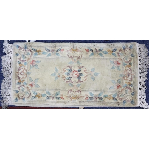 16 - WASHED CHINESE EMBOSSED RUG with rose pattern centre medallion, floral and foliate scroll spandrels ... 