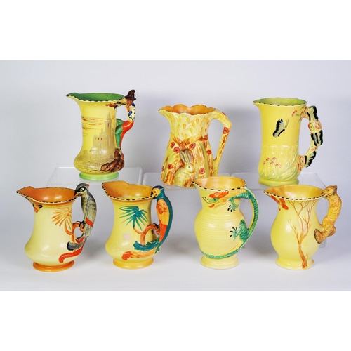 7 - SIX BURLEIGH WARE YELLOW GLAZED POTTERY JUGS WITH MOULDED HANDLES, including: PIED PIPER, PARROT, SQ... 