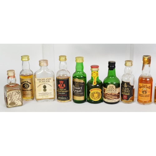 107 - TWENTY THREE VINTAGE VARIOUSLY SHAPED MINIATURE BOTTLES OF MALT, BLENDED AND OTHER WHISKY BASED SPIR... 