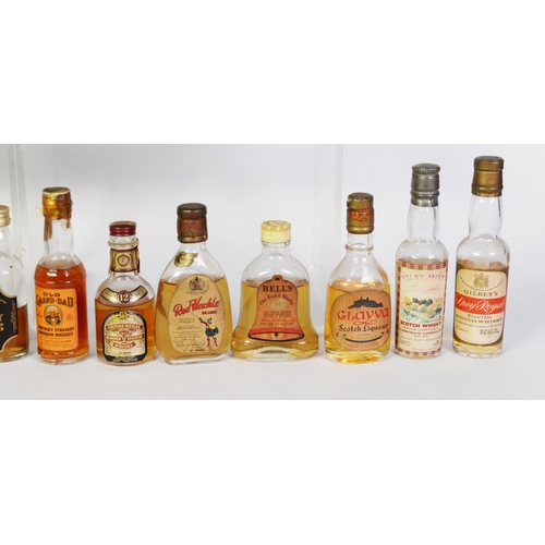 107 - TWENTY THREE VINTAGE VARIOUSLY SHAPED MINIATURE BOTTLES OF MALT, BLENDED AND OTHER WHISKY BASED SPIR... 