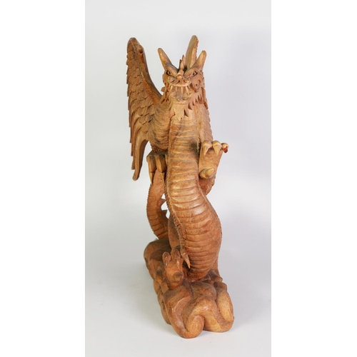 245 - LARGE SOUTH-EAST ASIAN WOOD CARVING OF A REARING WINGED DRAGON, on cloud carved base, 19 ½” (49.5 cm... 