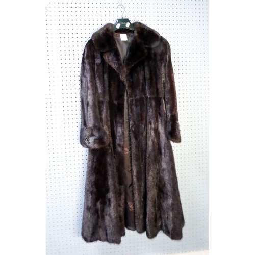 318 - LONG, FULL-LENGTH DARK BROWN MINK COAT, with short revered collar, button over cuff feature and butt... 