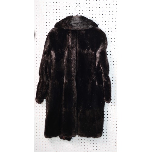 319 - LADY'S BLACK THREE-QUARTER LENGTH FUR COAT with short revered collar, single breasted hook fastening... 