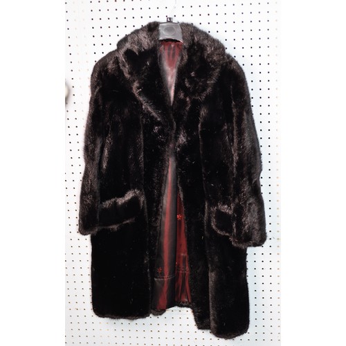 319 - LADY'S BLACK THREE-QUARTER LENGTH FUR COAT with short revered collar, single breasted hook fastening... 