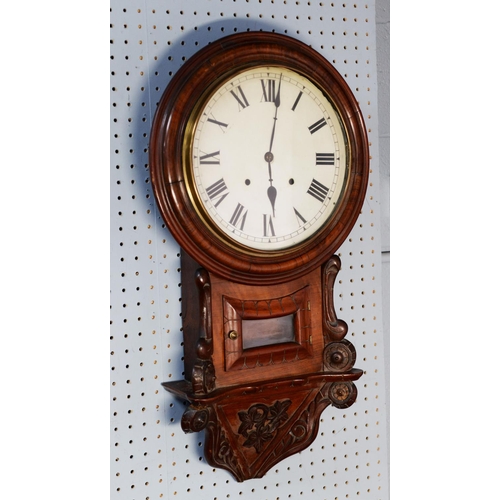 36 - LATE NINETEENTH CENTURY CARVED WALNUT DROP DIAL WALL CLOCK, with 12” enamelled Roman dial and the ca... 