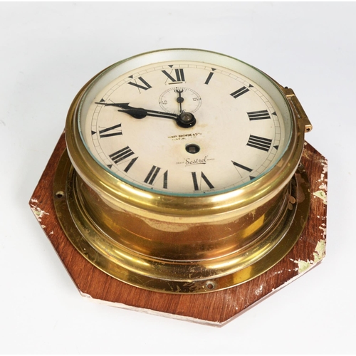 54 - SESTREL BRASS SHIP’S BULKHEAD WALL CLOCK, of typical form with subsidiary seconds dial, the back pla... 