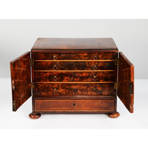 201 - EARLY NINETEENTH CENTURY FIGURED MAHOGANY TABLE TOP SMALL COLLECTORS CABINET, the moulded oblong top... 