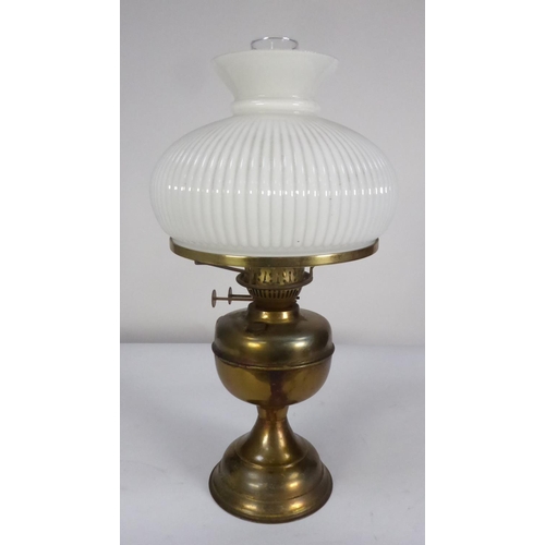 83 - BRASS OIL TABLE LAMP, with fluted opaque white glass shade and clear chimney, 19 ¾” (50.2cm) high